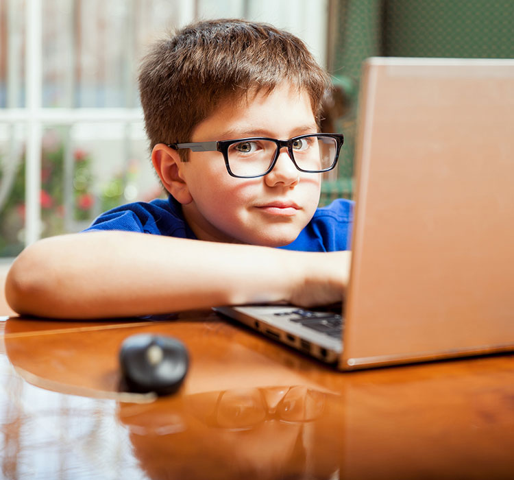bigstock-Kid-Doing-Homework-On-A-Laptop-84634460